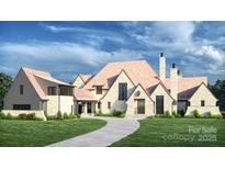 Stunning exterior elevation of a two-story home with a winding driveway and lush green lawn at 5015 Hardison Rd, Charlotte, NC 28226