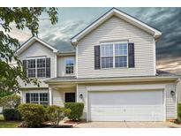Charming two-story home with white siding, black shutters, and a two-car garage at 6332 Sackett Way, Charlotte, NC 28269