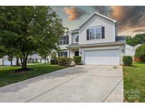 Charming two-story home with a well-manicured lawn and a spacious driveway leading to an attached two-car garage at 6332 Sackett Way, Charlotte, NC 28269
