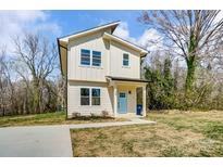 Charming two-story home with a light blue front door and manicured landscaping at 709 Catawba St, Lincolnton, NC 28092