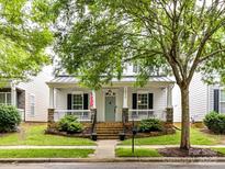 Charming single-Gathering home with a welcoming front porch and well-manicured lawn at 10515 Royal Winchester Dr, Charlotte, NC 28277