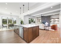 Bright, open kitchen with island, modern appliances, and seamless flow to dining and living areas at 111 Monbo Meadows Ln, Statesville, NC 28677