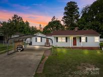 Charming single-story home features a covered parking, well-manicured lawn, and welcoming curb appeal at 1333 Washington Ln, Kannapolis, NC 28083