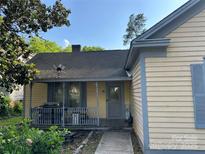 Charming home featuring a cozy front porch with vintage-style railings, providing a welcoming entrance at 142 Wylie St, Chester, SC 29706