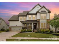 Charming two-story home with a landscaped yard and a welcoming front porch at 14228 Twin Eagles Ln, Charlotte, NC 28278
