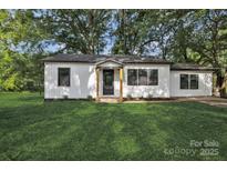 Charming home with a well-manicured lawn and a freshly painted exterior and black trim at 1739 16Th Ne St, Hickory, NC 28601