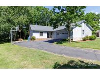 Charming single-story home featuring a well-maintained yard and a long paved driveway at 2011 20Th Street Ne Pl, Hickory, NC 28601