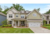 Charming two-story home featuring a covered front porch and attached two-car garage at 20307 Creek Bend Edge Ct # 10, Matthews, NC 28105