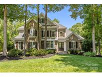 Beautiful two-story home with stone and siding exterior, complemented by lush landscaping and a well-manicured lawn at 238 Horton Grove Rd, Fort Mill, SC 29715