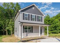 Two-story home with gray siding, black shutters, and a covered front porch at 304 Adams St, Salisbury, NC 28144