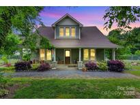 Charming home with lush landscaping, covered porch, and inviting curb appeal at 4335 E Nc 10 Hwy, Claremont, NC 28610
