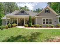 Charming single-story home with a welcoming front porch and manicured lawn at 4660 Gold Finch Dr, Denver, NC 28037