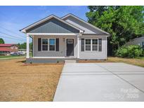 Charming single-story home featuring a covered front porch and a freshly poured concrete driveway at 528 S Caldwell St, Salisbury, NC 28144