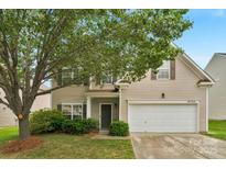 Charming two-story home features a well-manicured lawn, mature trees, and a two-car garage at 6104 Follow The Trl, Indian Trail, NC 28079