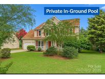 Charming two-story home with red shutters, covered porch and manicured lawn at 6614 Truman St, Indian Trail, NC 28079