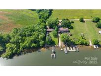 Stunning aerial view of a lake house with a private dock and lush green surroundings at 6822 Zelda Dr, Catawba, NC 28609