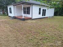 Charming one-story home with white siding, black shutters and a covered front porch. Ready to be renovated at 720 Mutual Rd, Gastonia, NC 28052
