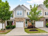 Charming townhome featuring a one-car garage, manicured lawn, and welcoming curb appeal at 7325 Overmountain Dr, Rock Hill, SC 29732