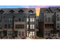 Beautiful three-story townhome featuring a brick and siding facade and a welcoming entrance at 743 Anderson St, Charlotte, NC 28205