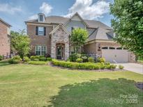 Charming two-story home with stone accents, manicured lawn, and attached two-car garage at 114 Reserve Ln, Fort Mill, SC 29707