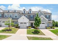 Charming townhomes feature attached garages, manicured lawns, and neutral color schemes at 13221 Gadwal Pintail Dr, Charlotte, NC 28262