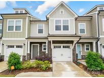 Charming townhome showcasing a stone facade, attached garage and manicured landscaping at 2018 Crooked Oak Ln, York, SC 29745