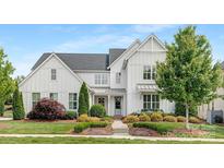 Charming two-story home with a beautifully landscaped front yard and attractive modern farmhouse design at 2026 Thatcher Way, Fort Mill, SC 29715