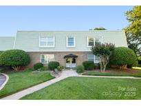 Charming building exterior featuring a well-manicured lawn and lush landscaping, perfect for enjoying the outdoors at 2638 Park Rd # H, Charlotte, NC 28209