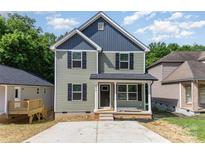 Charming two-story home with a cozy front porch and a neatly paved driveway at 312 Adams St, Salisbury, NC 28144