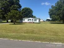 Charming home with mature trees on a well-maintained lawn at 338 Hickory Grove Rd, Harmony, NC 28634