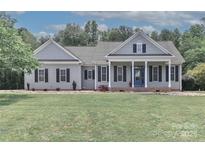 Charming home with gray siding, black shutters, well-manicured lawn, and a welcoming blue front door at 3709 Creek Ridge Dr, Denver, NC 28037