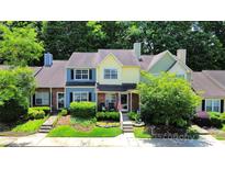 Charming townhomes with colorful facades, well-manicured landscaping, and inviting front entrances at 9216 Four Mile Creek Rd, Charlotte, NC 28277