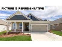 Charming single-Gathering home with a manicured lawn, a welcoming porch, and an attached two-car garage at 104 Noah Ln, Troutman, NC 28166
