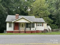 Charming single-story home with a front porch and mature trees at 1313 Lower Dallas Hwy Hwy, Dallas, NC 28034
