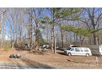 Picturesque property nestled amongst mature trees, a cozy single-story home, and multiple recreational vehicles at 2206 Meadow Rd, Clover, SC 29710