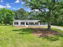 Charming white home featuring a well-manicured lawn and large tree for added curb appeal at 263 Fairway Cir, Rock Hill, SC 29730