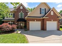 Traditional brick home featuring a well-manicured lawn and a convenient two-car garage at 3124 17Th Street Ne Ln, Hickory, NC 28601