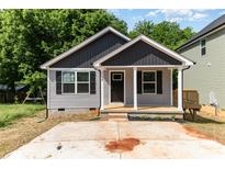 Charming single Gathering home features a covered porch, gray siding, and a concrete driveway at 314 Adams St, Salisbury, NC 28144