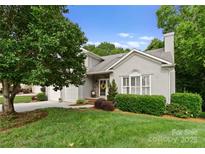 Charming stucco home with a well-maintained front yard and attached two-car garage at 4101 Fairway Downs Ct # 9, Charlotte, NC 28277