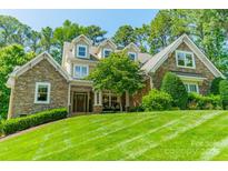 Beautiful stone-clad home featuring well-manicured lawn and inviting curb appeal at 4319 Sailview Dr, Denver, NC 28037