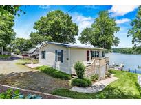 Charming lakeside cottage with a well-maintained lawn and inviting deck at 4920 Longfield St, Claremont, NC 28610