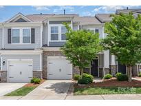Charming townhome with stone accents, two-car garage, and landscaped front yard at 724 Little Bluestem Dr, Lake Wylie, SC 29710