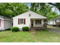 Charming single-story home featuring a cozy front porch and well-maintained landscaping at 730 Marble St, Charlotte, NC 28208