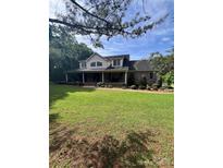 Charming two-story brick home with a welcoming covered porch and mature landscaping at 803 Freeman Rd, Concord, NC 28025