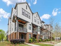 Charming townhome exteriors with brick accents and private balconies showcasing modern design and curb appeal at 933 E 36Th St, Charlotte, NC 28205