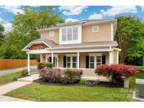 Charming two-story home with a cozy front porch and well-maintained landscaping at 14034 Cedar Pond Cir, Huntersville, NC 28078