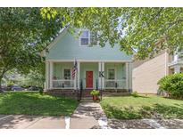 Charming two-story home featuring a welcoming front porch, red door, and an American flag waving proudly at 186 Gresham Ln, Mooresville, NC 28117