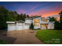 Stunning modern home with three-car garage and manicured lawn at twilight at 188 Blarney Rd, Mooresville, NC 28117
