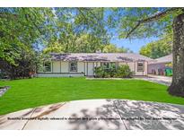 Charming home with a digitally enhanced lush green front yard, mature trees, and a welcoming exterior at 2000 Tyvola Rd, Charlotte, NC 28210