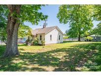A charming home features a classic exterior with a well-maintained lawn and mature trees at 3042 N Oxford St, Claremont, NC 28610